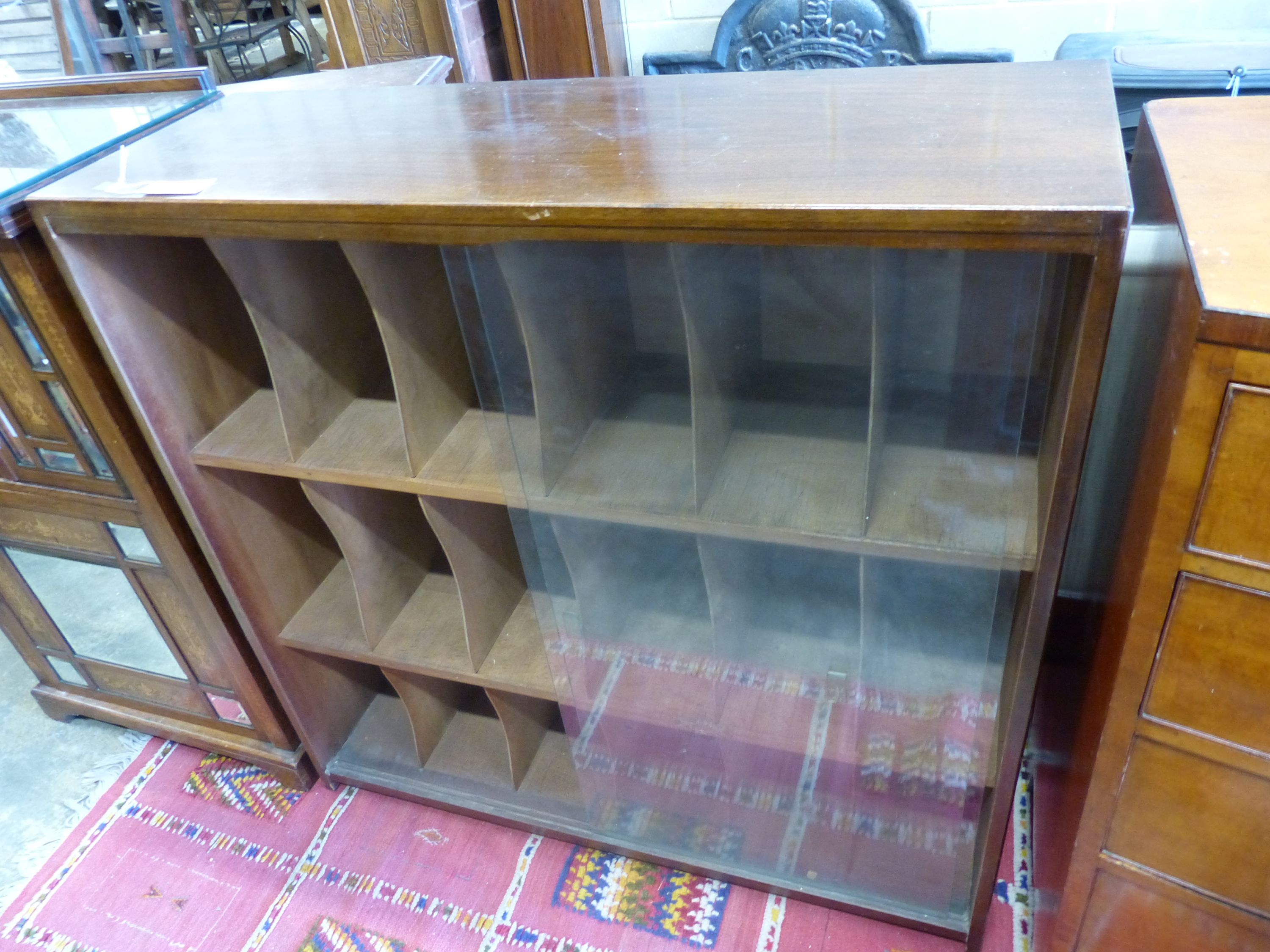 A mid century glazed teak eighteen section record cabinet, length 104cm, depth 35cm, height 104cm